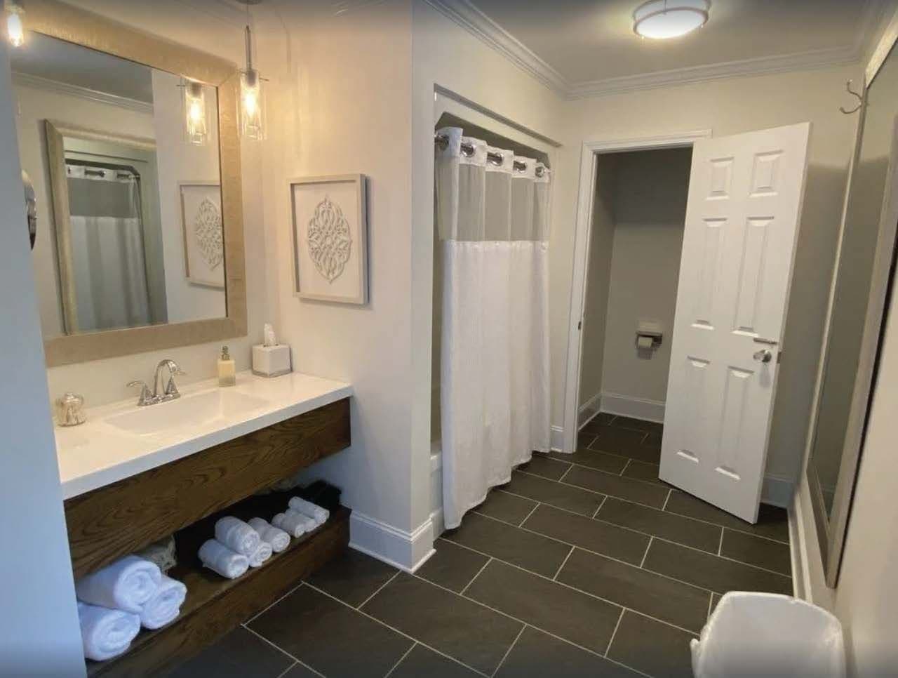 Upstairs Master EnSuite Bathroom - Sink, Shower/Bath, & A Toilet.