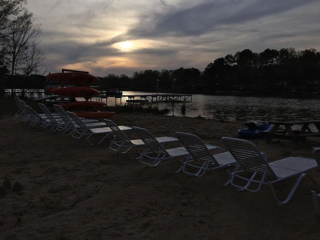 Sunset At The Beach. Lots Of Chaise Lounge Chairs & Picnic Tables.