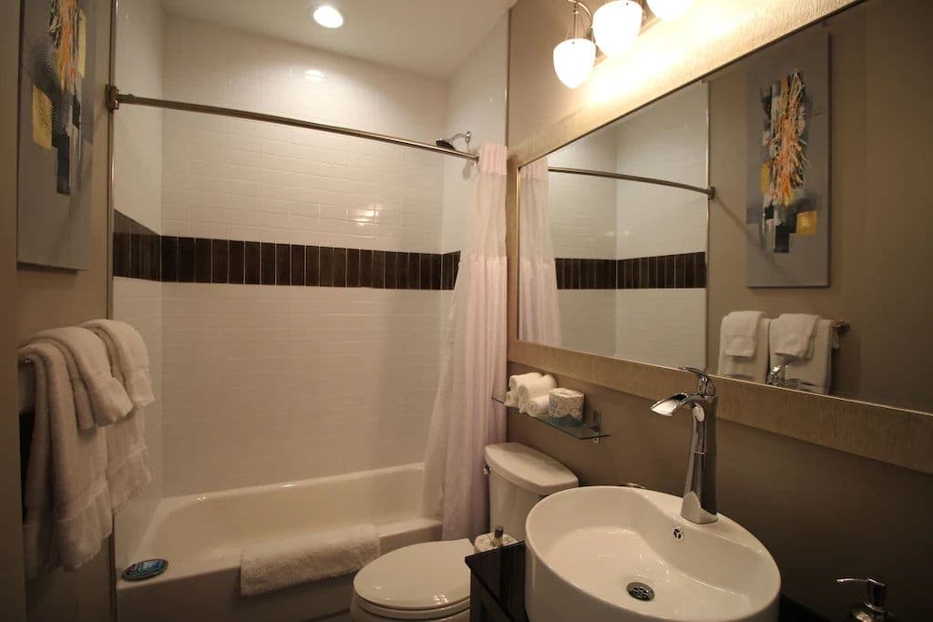 Upstairs Vaulted King EnSuite Bathroom - Sink, Shower/Bath, & A Toilet.